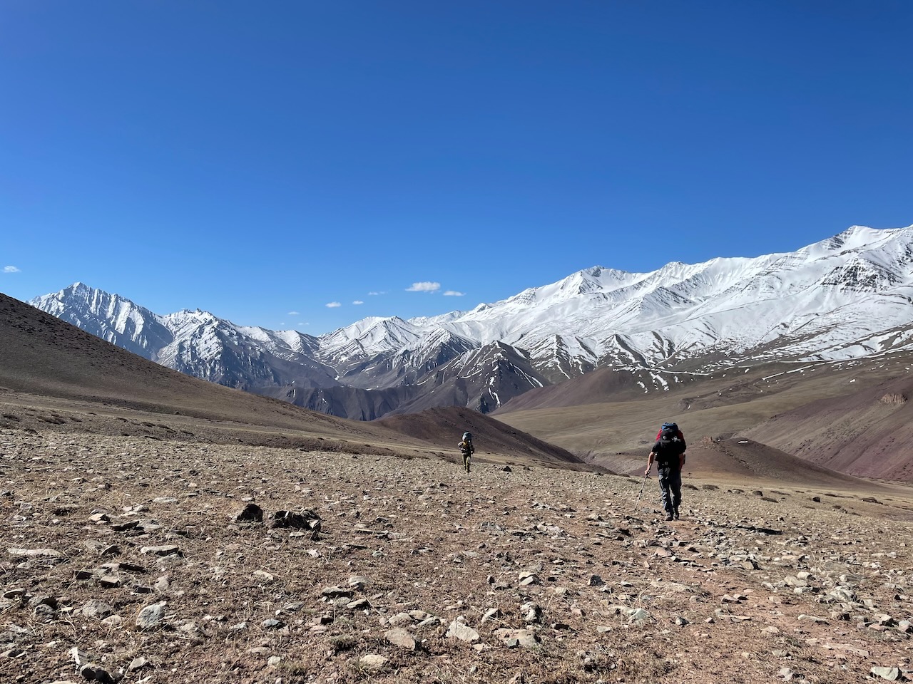 two people in a vast mountain ridge